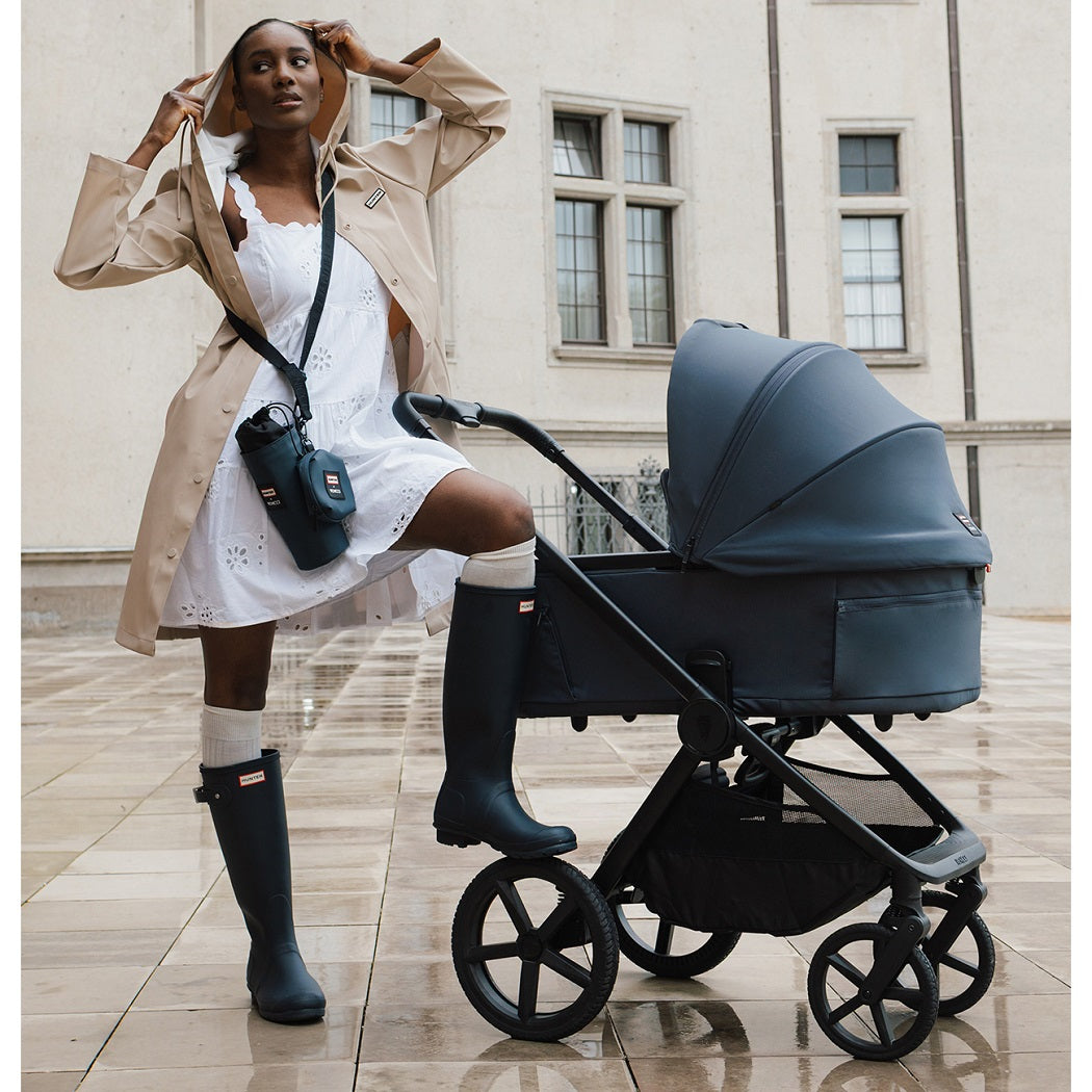 Hunter x Venicci Upline 3 Pram - Navy - woman in navy Hunter wellies with pram outdoors