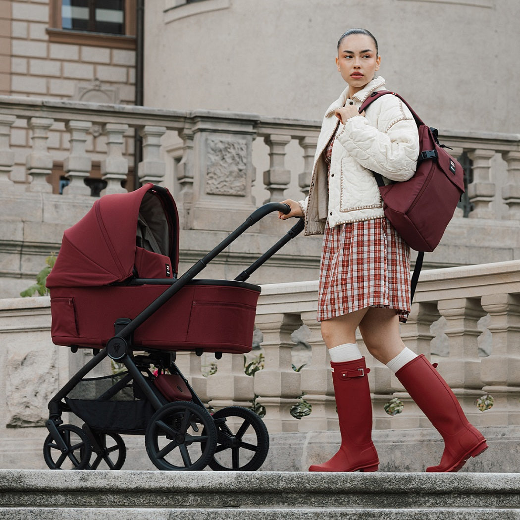 Hunter x Venicci Upline 3 Pram - Red - woman in red Hunter wellies with pram outdoors