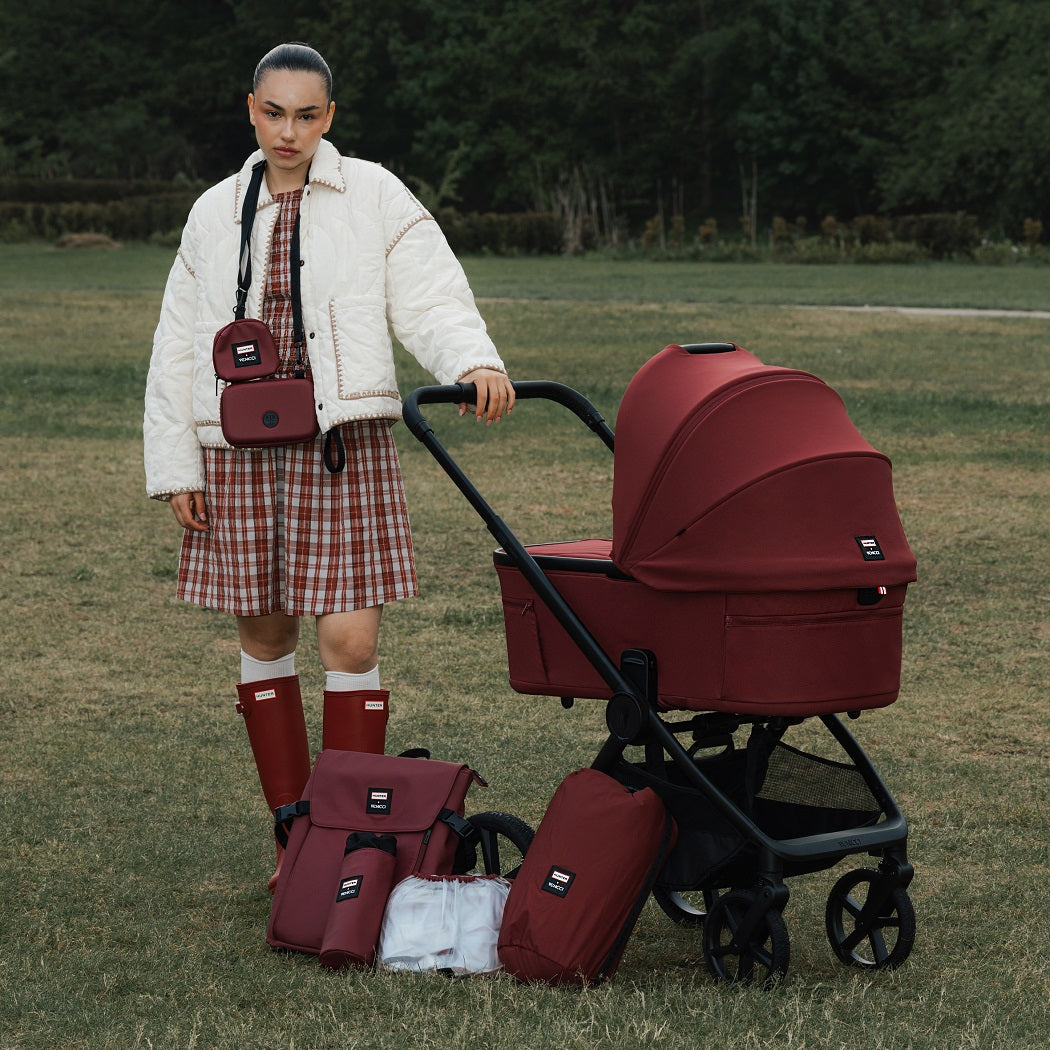 Hunter x Venicci Upline 3 Pram - Red - woman in red Hunter wellies with pram and matching accessories outdoors