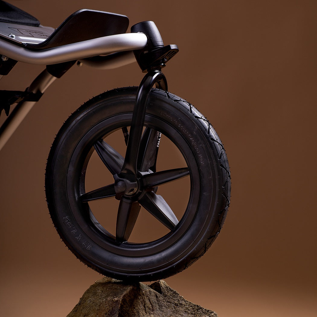 Mountain Buggy Urban Jungle V4 Pushchair - front wheel resting on a rock