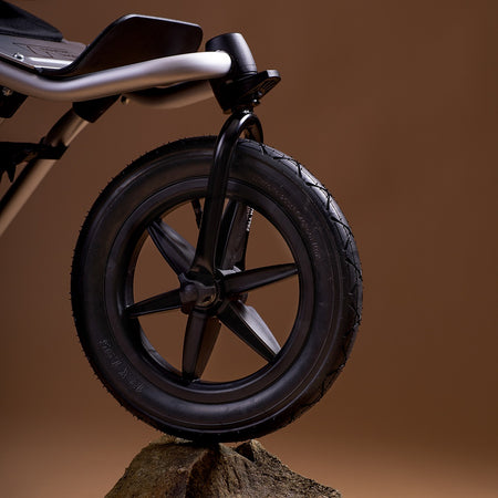 Mountain Buggy Urban Jungle V4 Pushchair - front wheel resting on a rock