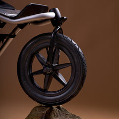 Mountain Buggy Urban Jungle V4 Pushchair - front wheel resting on a rock