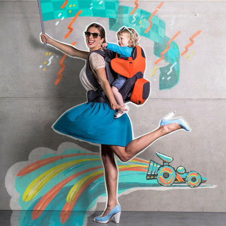 Phil & Teds Parade Baby Carrier - lifestyle image, showing child in Orange/Grey option