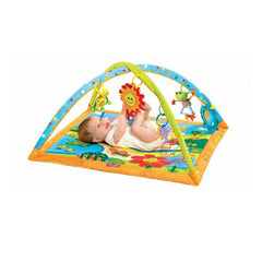 Tiny Love Gymini Playmat (Sunny Day) - showing a baby playing with the hanging toys