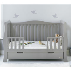 Obaby Stamford Luxe Sleigh Cot Bed with Drawer (Warm Grey) - lifestyle image, shown here as the junior bed with side rails