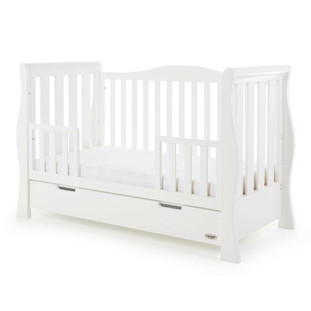 Obaby Stamford Luxe Sleigh Cot Bed with Drawer (White) - quarter view, shown as the junior bed with the protective side rails