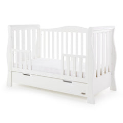 Obaby Stamford Luxe Sleigh Cot Bed with Drawer (White) - quarter view, shown as the junior bed with the protective side rails