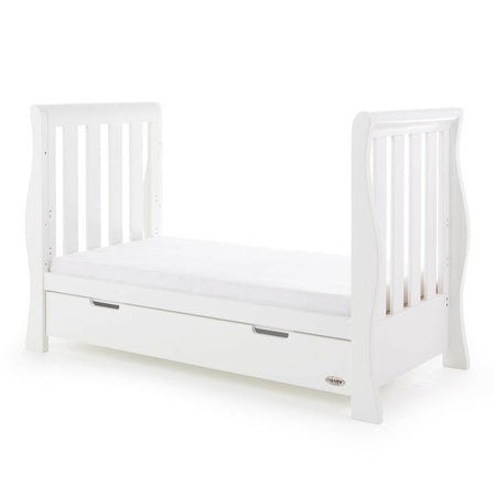 Obaby Stamford Luxe Sleigh Cot Bed with Drawer (White) - quarter view, shown as the junior bed