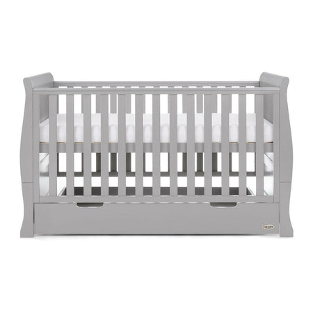Obaby Stamford Sleigh Cot Bed (Warm Grey) - side view, shown with the mattress base at its highest level