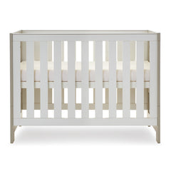 Obaby Nika Mini Cot Bed (Grey Wash & White) - side view, shown here with the mattress base at its highest level (mattress not included, available separately)