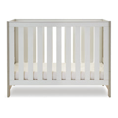 Obaby Nika Mini Cot Bed (Grey Wash & White) - side view, shown here with the mattress base at its lowest level (mattress not included, available separately)