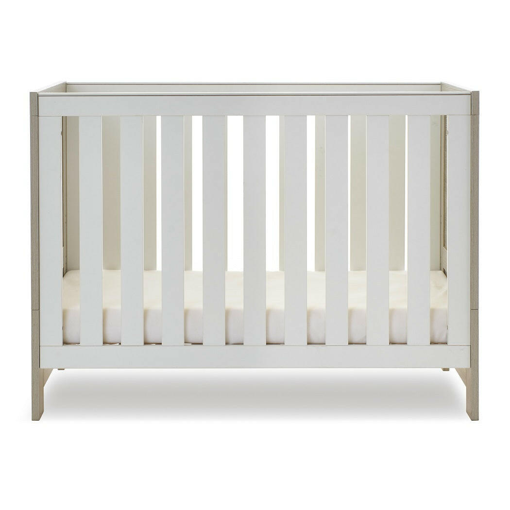 Obaby Nika Mini Cot Bed - Grey Wash & White) - side view, with mattress base at lowest level