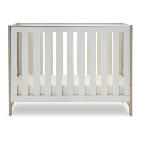 Obaby Nika Mini Cot Bed - Grey Wash & White) - side view, with mattress base at lowest level