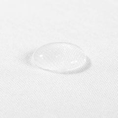 ClevaMama Tencel Waterproof Mattress Protector - Crib (90x40cm) - showing the protector`s waterproof properties