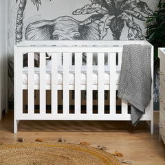 Obaby Nika Cot Bed (White Wash) - lifestyle image (mattress, bedding and accessories not included)