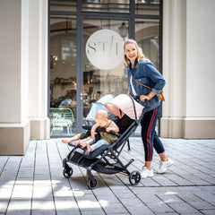 Hauck Swift X Duo Double Pushchair (Black) - lifestyle image, shown here with blue and pink hoods (coloured hoods not included, available separately)