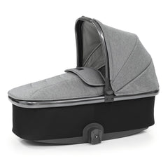 BabyStyle Oyster 3 Gunmetal ESSENTIAL Bundle (Moon) - quarter view, showing the carrycot with its hood and apron