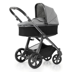 BabyStyle Oyster 3 Gunmetal ESSENTIAL Bundle (Moon) - quarter view, showing the carrycot and chassis together as the pram