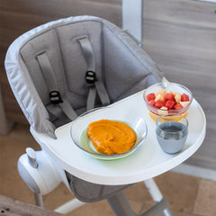 BEABA Seat Cushion for Up and Down Highchair - Infant/Toddler (Grey) - showing the cushion fitted to the highchair with its safety harness pulled through its fitting slots (cup, bowl and plate not included)