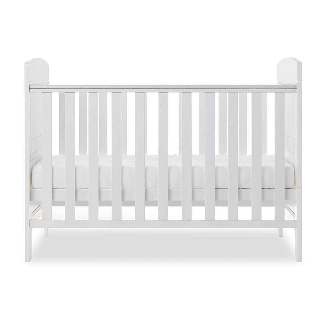 Obaby Grace Mini Cot Bed (White) - side view, shown with the mattress base at its middle level (mattress not included, available separately)