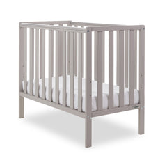 Obaby Bantam Space Saver Cot with Fibre Mattress (Warm Grey - quarter view, shown here with the included mattress