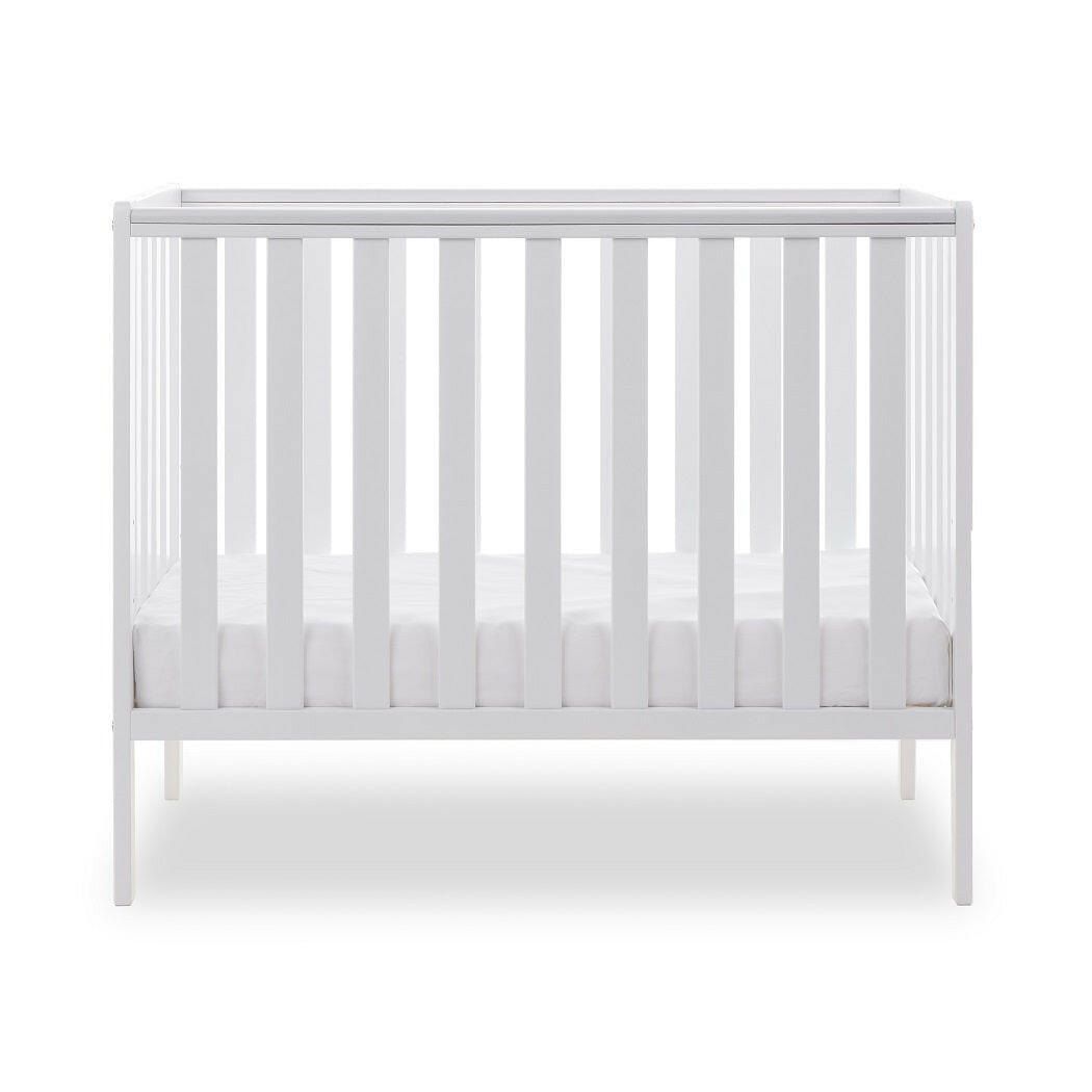 Obaby Bantam Space Saver Cot (White) - side view, shown with mattress base at its lowest level