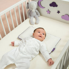 ClevaMama ClevaFoam Baby Pillow - lifestyle image, shown being used in a cot