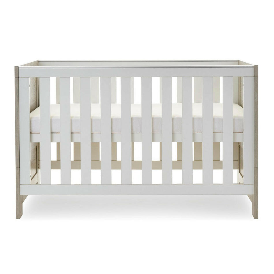 Obaby Nika Cot Bed - Grey Wash & White - side view, with mattress base at its highest level