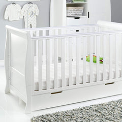 Obaby Stamford Sleigh Cot Bed with Drawer (White) - lifestyle image, shown here with the cot (mattress and accessories not included, available separately)