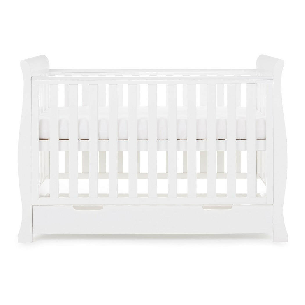 Obaby Stamford Mini Sleigh Cot Bed with Drawer (White) - side view, shown here with the mattress base at its highest level (mattress not included)