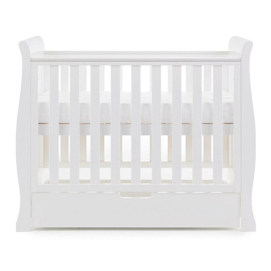 Obaby Stamford Space Saver Cot (White) - side view, shown here with mattress base at its highest level (mattress not included, available separately)