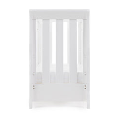 Obaby Stamford Space Saver Cot (White) - end view, shown here with mattress base at its lowest level