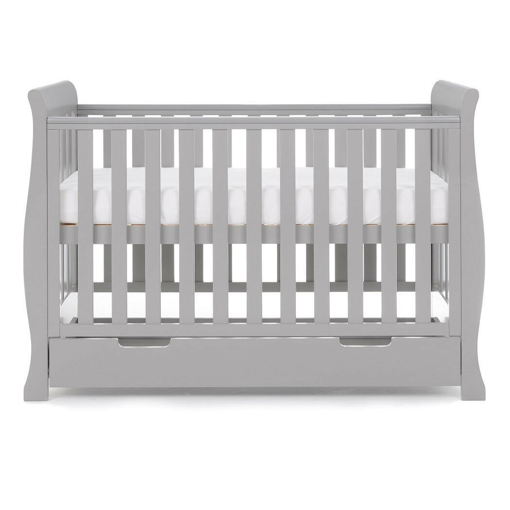 Obaby Stamford Mini Sleigh Cot Bed with SPRUNG Mattress (Warm Grey) - side view, showing the cot with the mattress base at its highest level