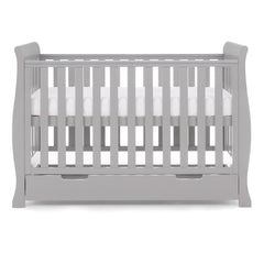 Obaby Stamford Mini Sleigh Cot Bed with SPRUNG Mattress (Warm Grey) - side view, showing the cot with the mattress base at its highest level