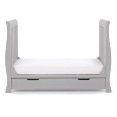 Obaby Stamford Mini Sleigh Cot Bed with SPRUNG Mattress (Warm Grey) - side view, shown here as the junior bed