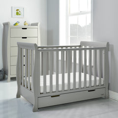 Obaby Stamford Mini Sleigh Cot Bed with SPRUNG Mattress (Warm Grey) - lifestyle image (tall drawers not included)